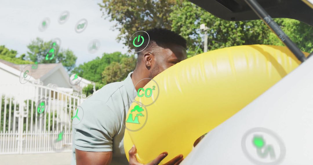 Eco-Conscious Man Packing Inflatable Ring into Car Trunk on Sunny Day