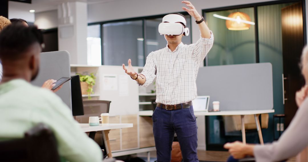 Man Demonstrating VR Technology to Colleagues in Modern Office