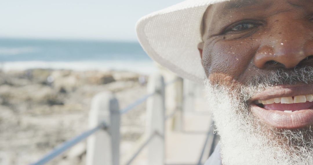 Smiling Elderly Man with White Beard at a Seaside - Free Images, Stock Photos and Pictures on Pikwizard.com