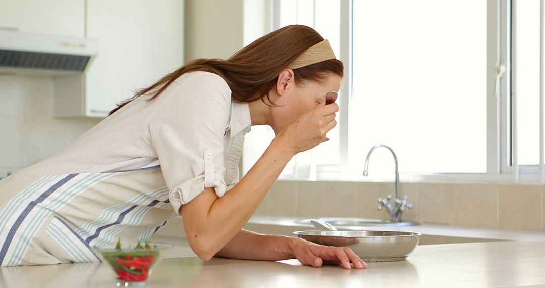 Young Woman Tasting Food in Modern Kitchen - Free Images, Stock Photos and Pictures on Pikwizard.com