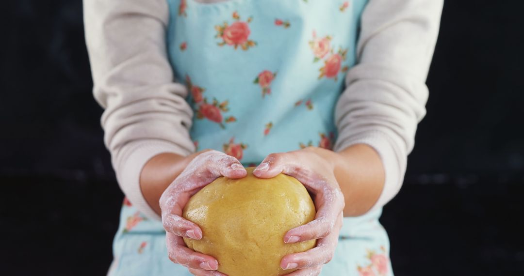 Person Holding Dough in Hands While Baking with Floral Apron - Free Images, Stock Photos and Pictures on Pikwizard.com