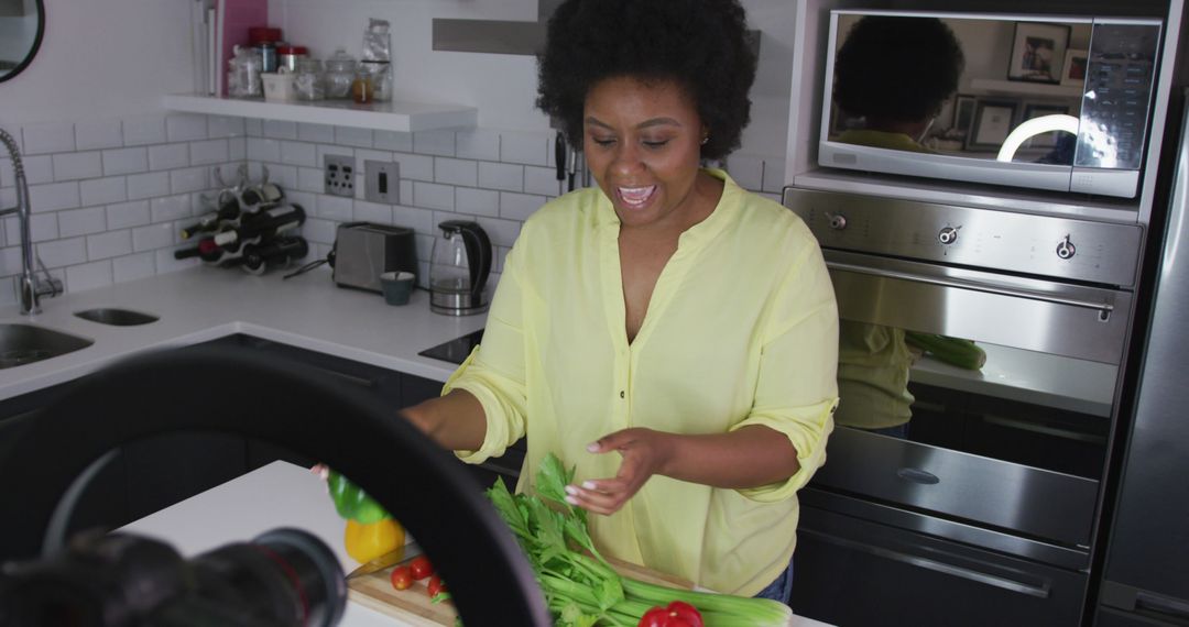 Happy Woman Cooking and Preparing Fresh Vegetables in Modern Kitchen - Free Images, Stock Photos and Pictures on Pikwizard.com