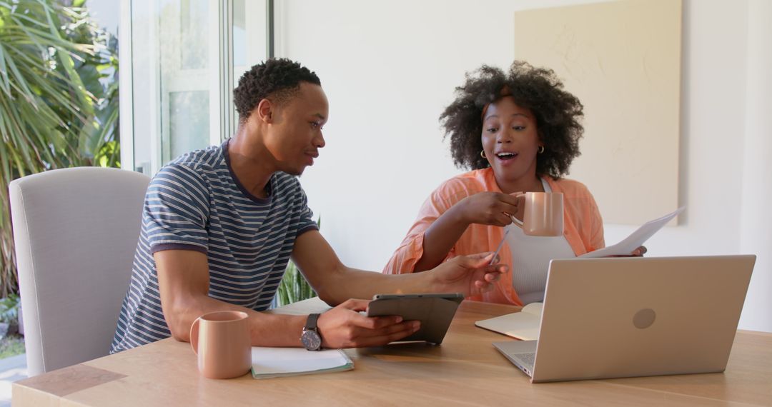 Couple Collaborating on Digital Work Task in Home Office