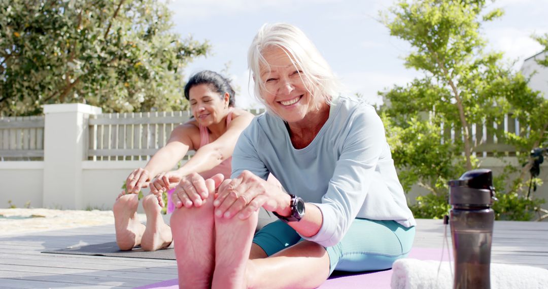 Smiling Senior Women Stretching During Outdoor Yoga Session - Free Images, Stock Photos and Pictures on Pikwizard.com