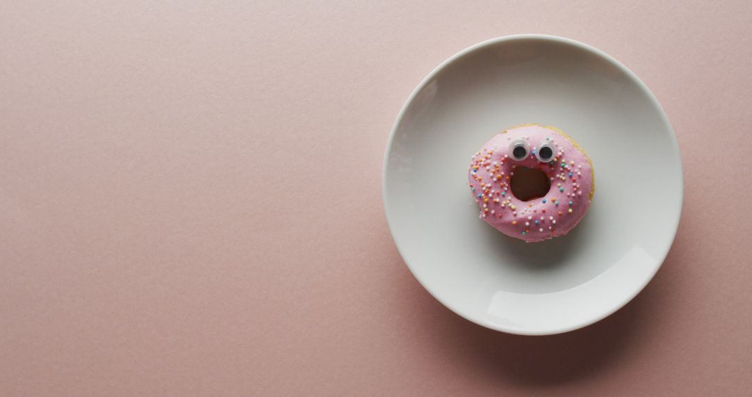 Colorful Sprinkle Donut with Googly Eyes on White Plate - Free Images, Stock Photos and Pictures on Pikwizard.com