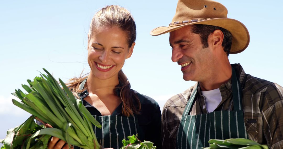 Smiling Farmers Harvesting Fresh Green Vegetables Outdoors - Free Images, Stock Photos and Pictures on Pikwizard.com