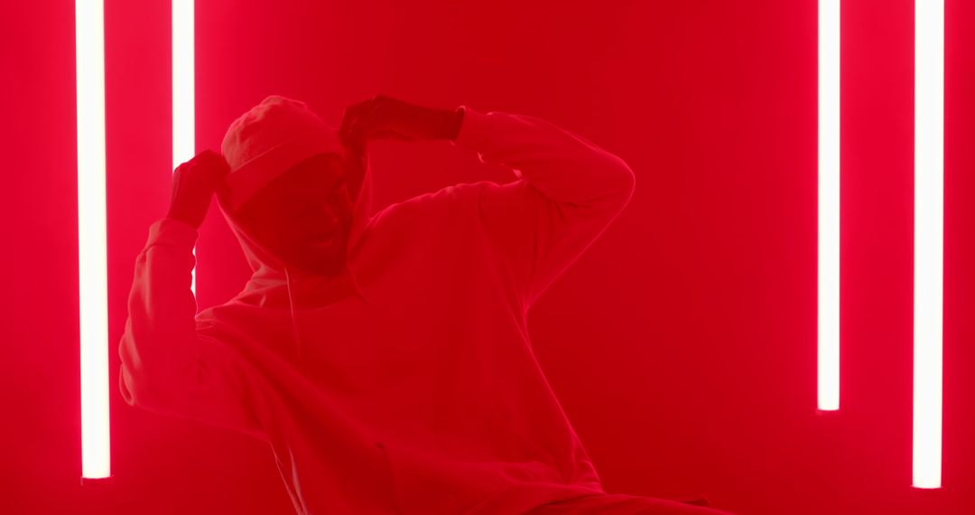Man in White Hoodie with Neon Red Lighting
