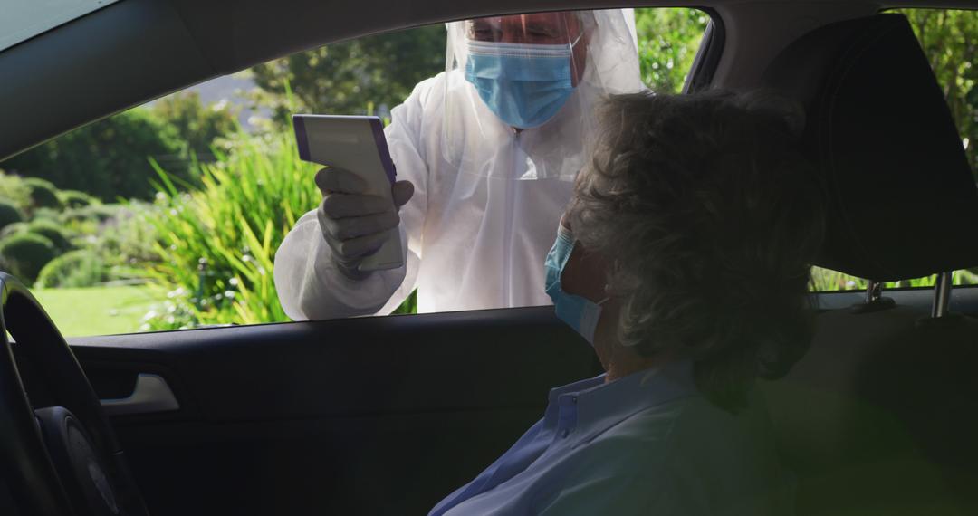 Health worker checking temperature of senior woman in car with infrared thermometer - Free Images, Stock Photos and Pictures on Pikwizard.com