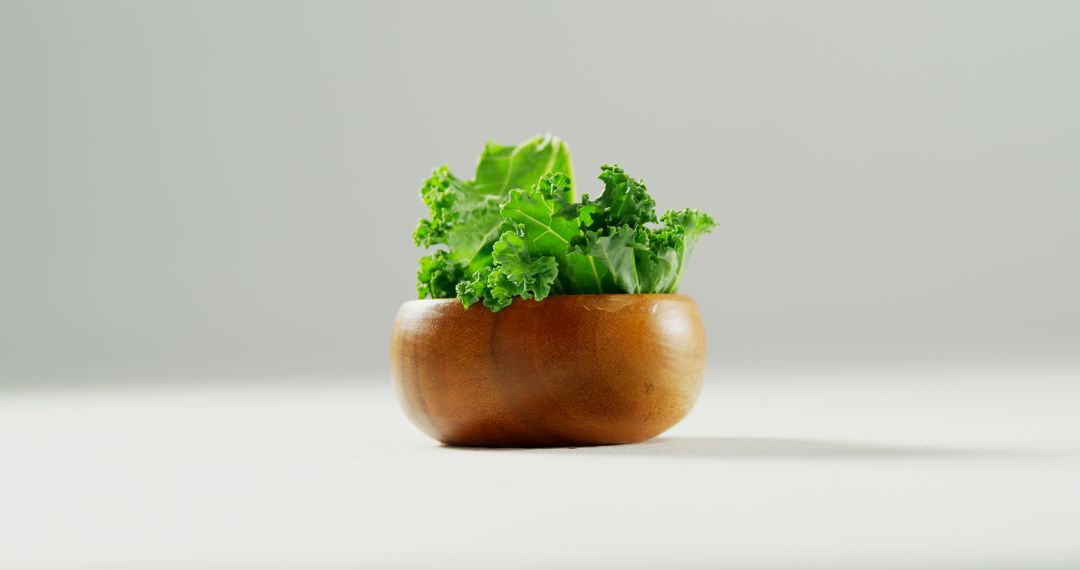 Fresh Kale Leaves in Wooden Bowl on White Background - Free Images, Stock Photos and Pictures on Pikwizard.com