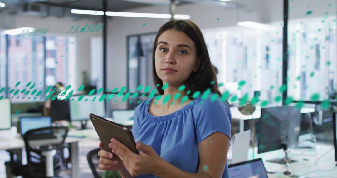 Businesswoman Using Tablet with Financial Data Overlay in Modern Office
