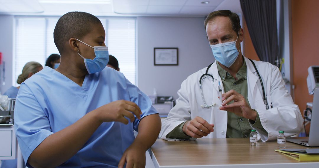 Healthcare Workers Discussing Patient Treatment at Hospital - Free Images, Stock Photos and Pictures on Pikwizard.com