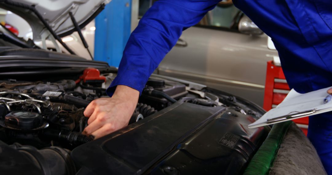 Auto Mechanic Inspecting Car Engine in Repair Shop - Free Images, Stock Photos and Pictures on Pikwizard.com