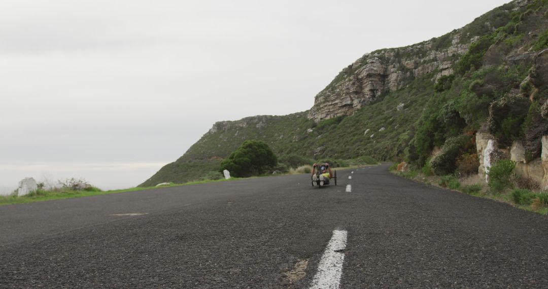 Remote Scooter Rider on Empty Mountain Road - Free Images, Stock Photos and Pictures on Pikwizard.com