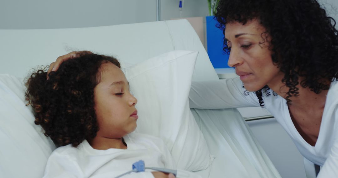 Mother comforting her sick daughter in hospital bed - Free Images, Stock Photos and Pictures on Pikwizard.com