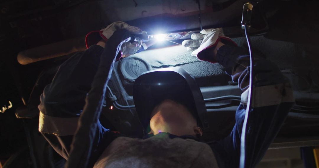 Technical Skill in Action: Welder Working Under Vehicle Chassis