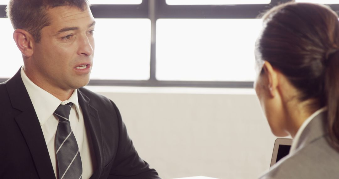 Professional Business Meeting Between Colleagues in Office Setting