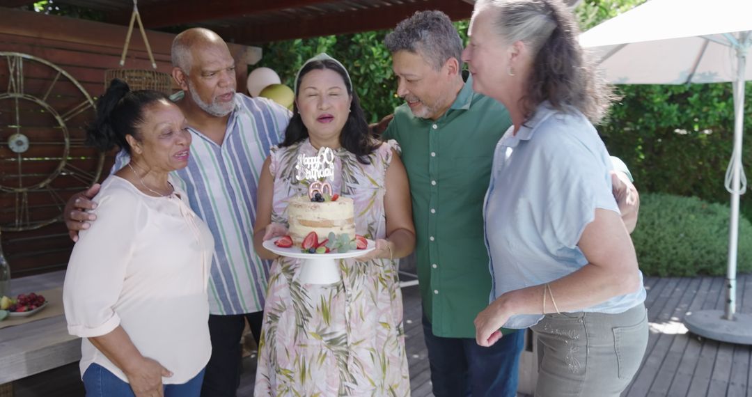 Senior Group Celebrating Birthday with Cake in Garden