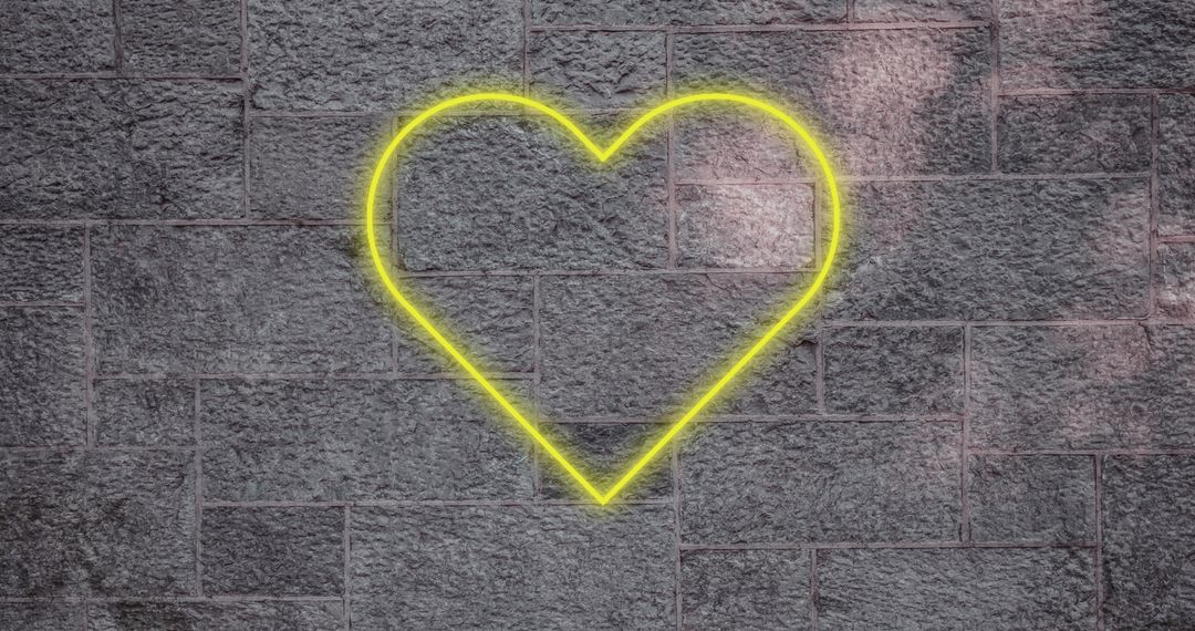 Yellow Heart Neon Light on Gray Brick Wall