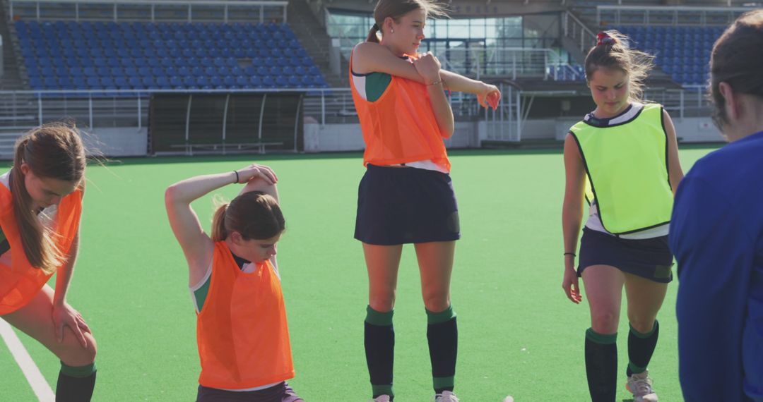 Female Field Hockey Players Preparing for Practice on Turf Field - Free Images, Stock Photos and Pictures on Pikwizard.com