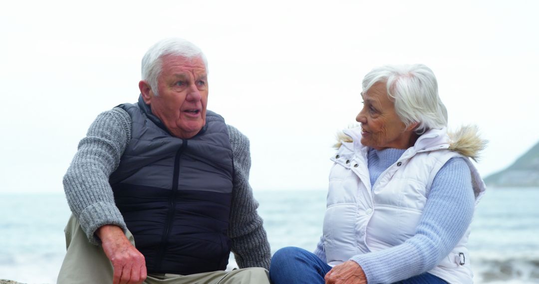 Senior Couple Enjoying Conversation by Seaside - Free Images, Stock Photos and Pictures on Pikwizard.com