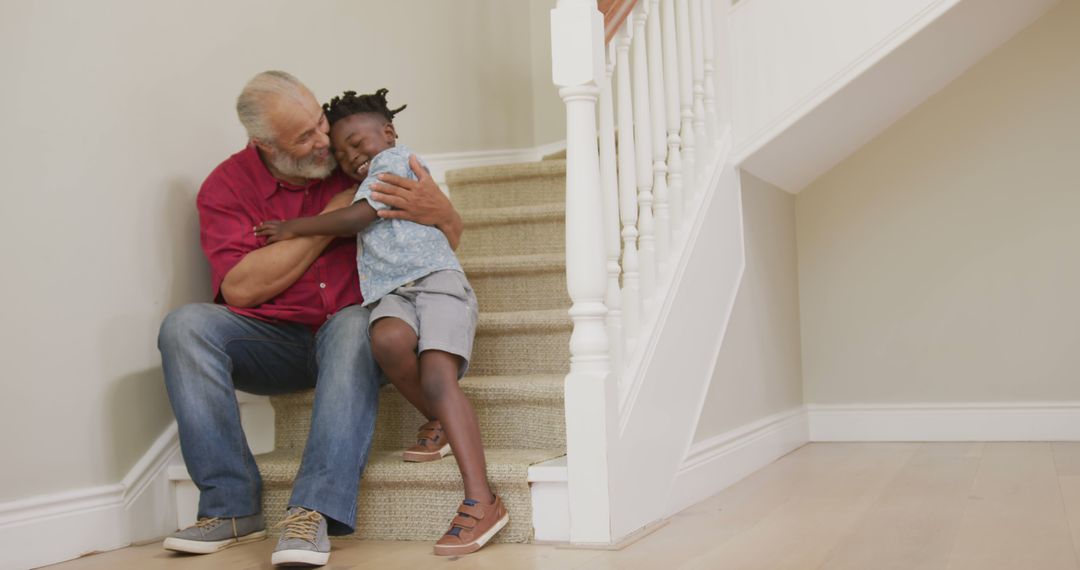 Grandfather Comforting Grandchild on Staircase at Home - Free Images, Stock Photos and Pictures on Pikwizard.com