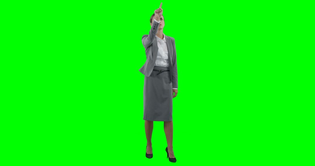 Businesswoman Pointing Upwards with Green Screen Background - Free Images, Stock Photos and Pictures on Pikwizard.com