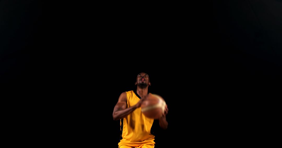 Basketball player aiming for hoop against dark background - Free Images, Stock Photos and Pictures on Pikwizard.com