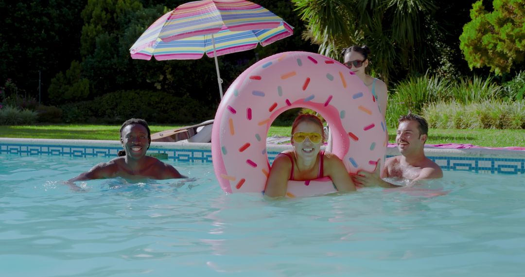 Friends Enjoying Summer Fun in Pool with Donut Float