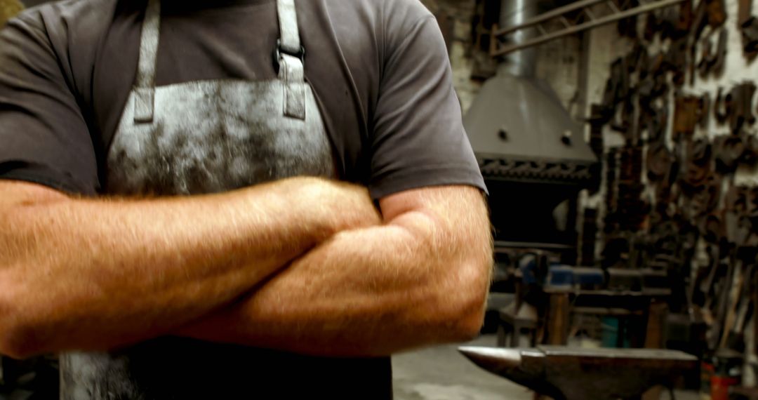 Blacksmith with Crossed Arms in Workshop - Free Images, Stock Photos and Pictures on Pikwizard.com