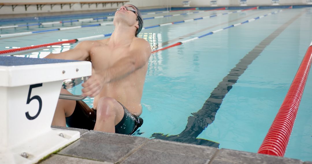 Competitive Swimmer in Action Making Splash During Training