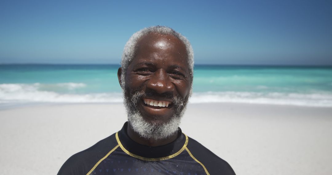 Happy Elderly Man Smiling at Beach in Bright Sunlight - Free Images, Stock Photos and Pictures on Pikwizard.com