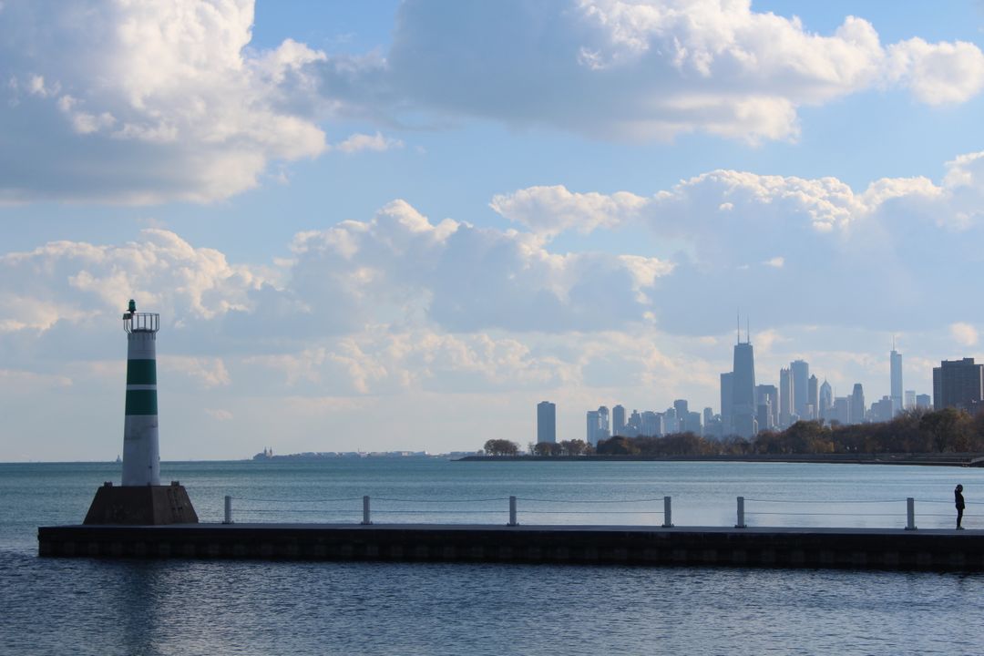 Scenic View of Skyline and Lighthouse by Calm Waters - Free Images, Stock Photos and Pictures on Pikwizard.com