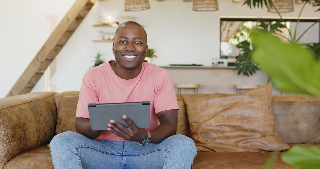 Smiling Man Relaxing with Tablet in Modern Living Room