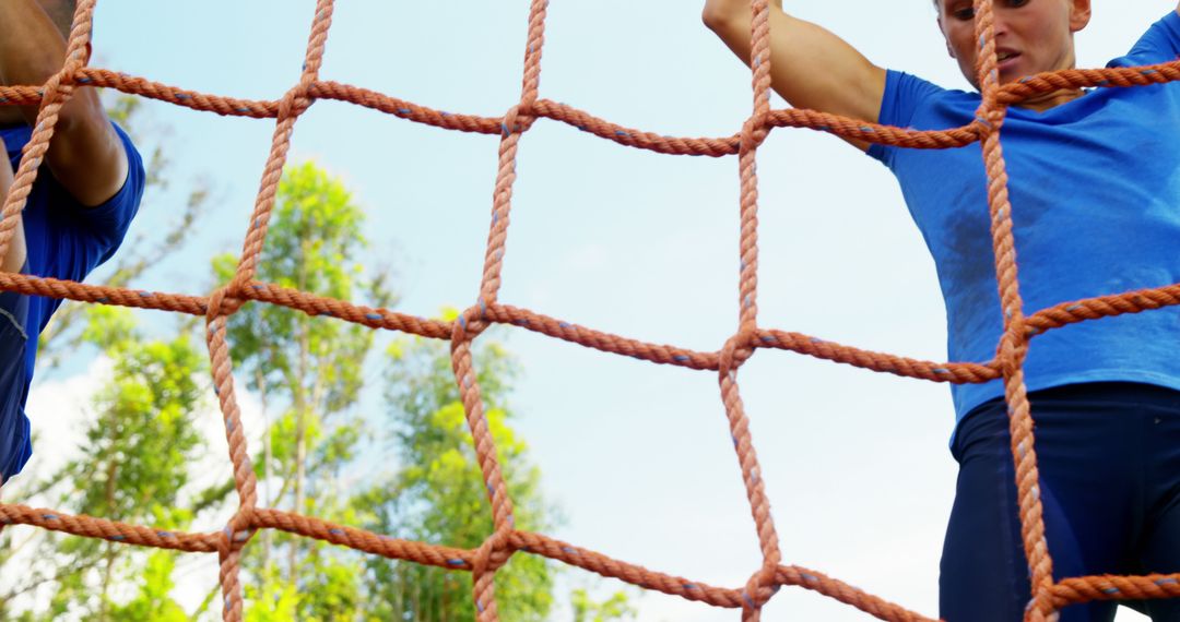 Determined Boys Climbing Rope Net Outdoors for Fitness and Adventure
