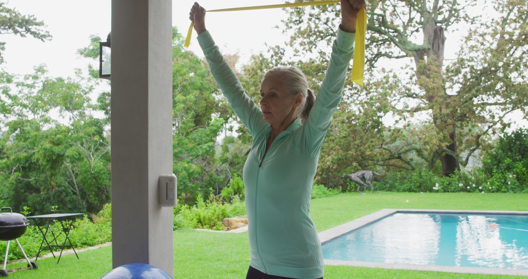 Active Senior Woman Exercising with Resistance Band by the Pool - Free Images, Stock Photos and Pictures on Pikwizard.com