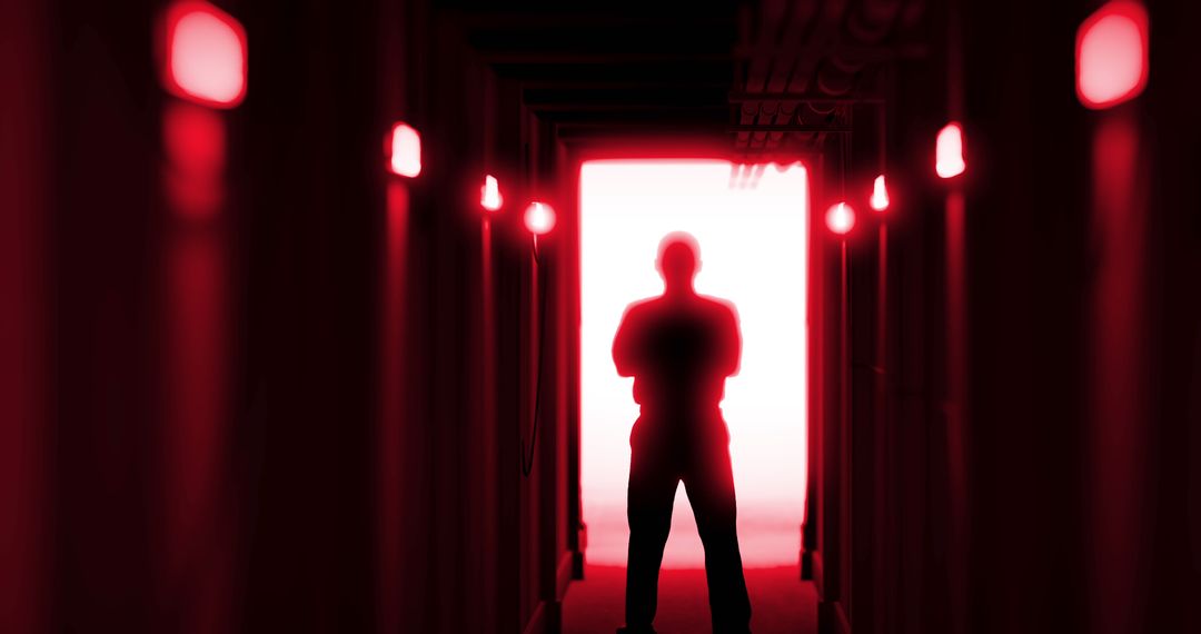 Silhouette of Man in Eerie Red Corridor