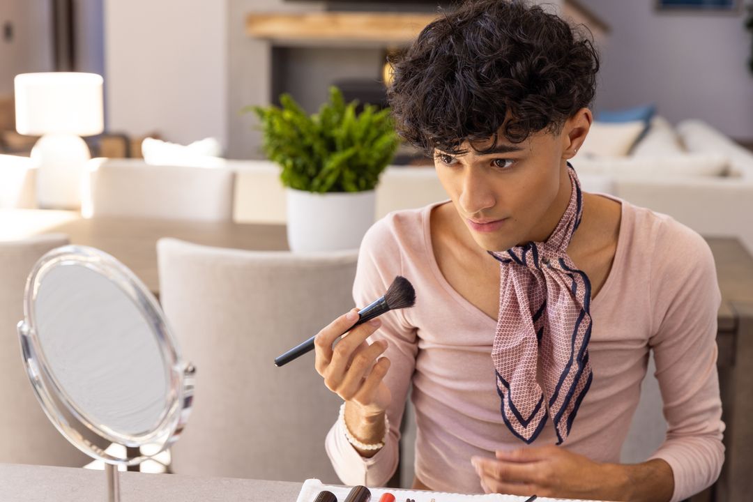 Man Applying Makeup with Brush and Mirror at Home