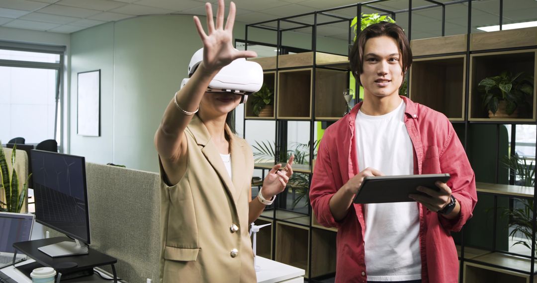 Colleagues Experiencing Virtual Reality in Modern Office Space