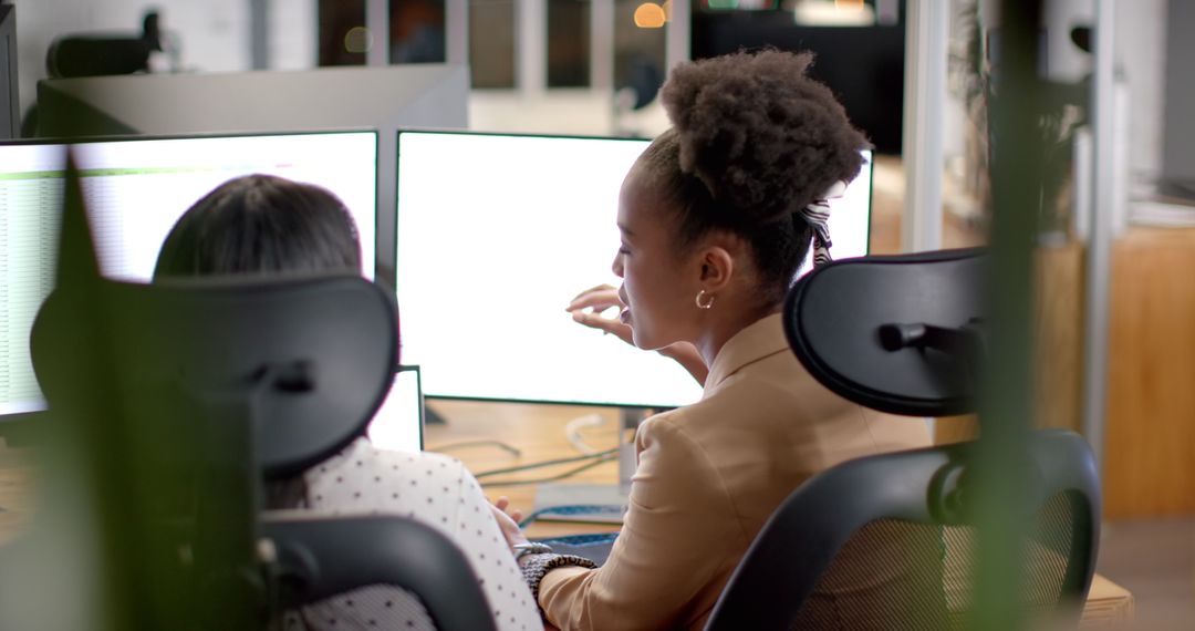 Diverse Team Analyzing Data on Computer Dual Monitors in Office