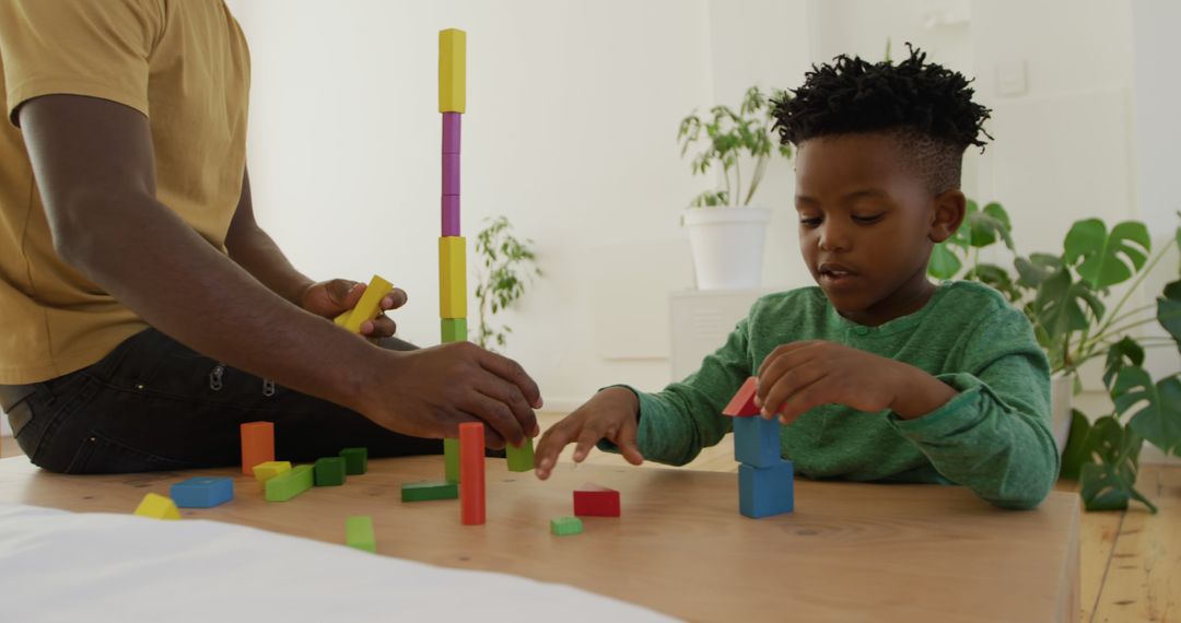 Father and Son Building Tower with Colorful Blocks at Home - Free Images, Stock Photos and Pictures on Pikwizard.com