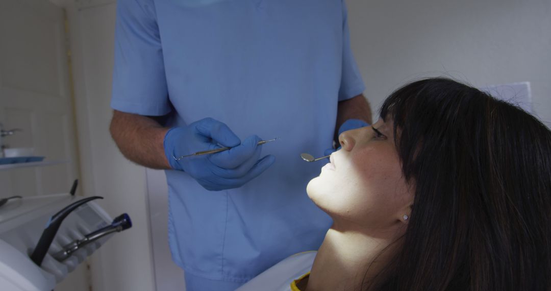 Dentist Examining Female Patient's Teeth in Clinic - Free Images, Stock Photos and Pictures on Pikwizard.com