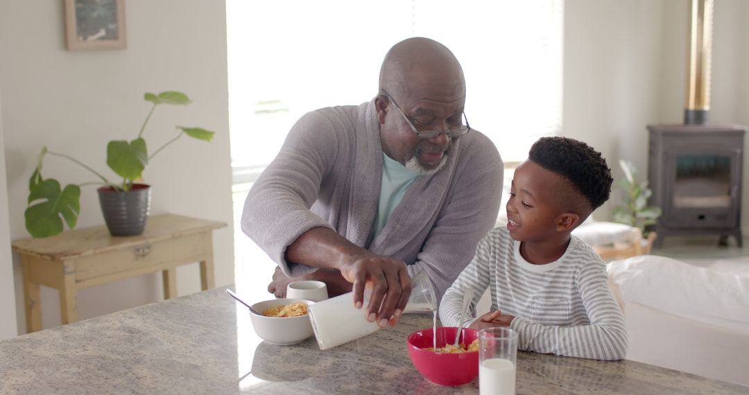 Grandfather Pouring Cereal for Happy Grandson at Breakfast Table - Free Images, Stock Photos and Pictures on Pikwizard.com