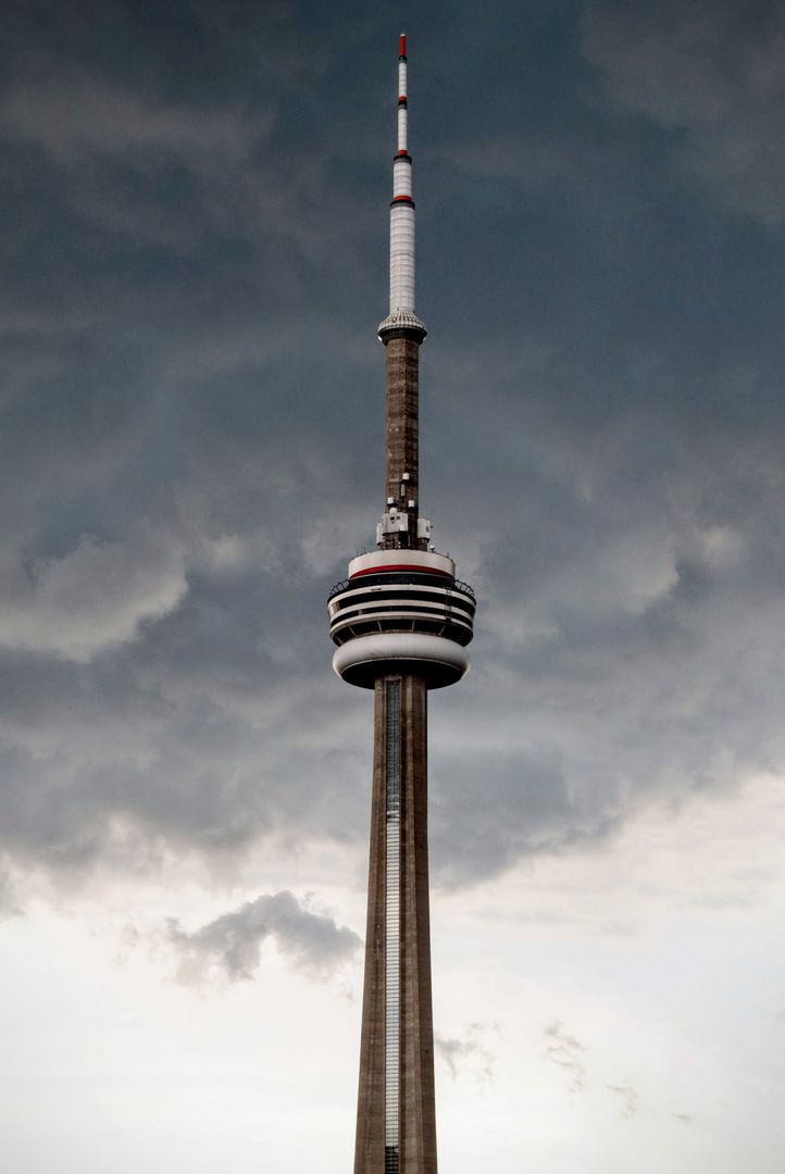 CN Tower against dramatic cloudy sky in Toronto - Free Images, Stock Photos and Pictures on Pikwizard.com