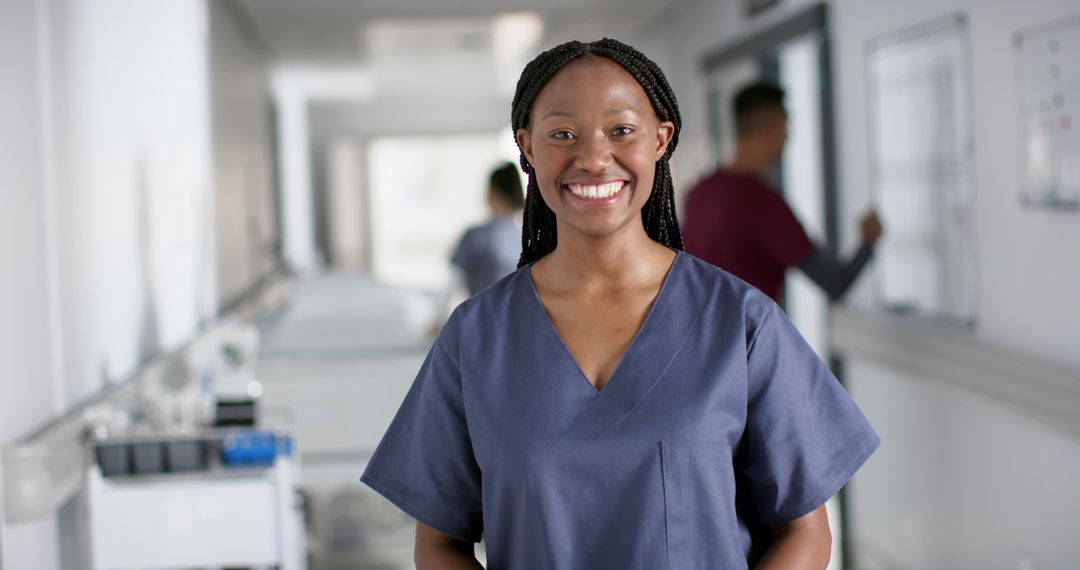 Smiling Nurse in Hospital Corridor - Free Images, Stock Photos and Pictures on Pikwizard.com