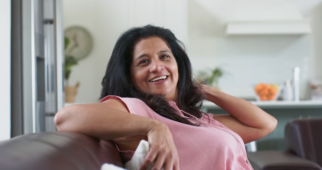 Happy Woman Relaxing on Couch in Modern Living Room - Free Images, Stock Photos and Pictures on Pikwizard.com