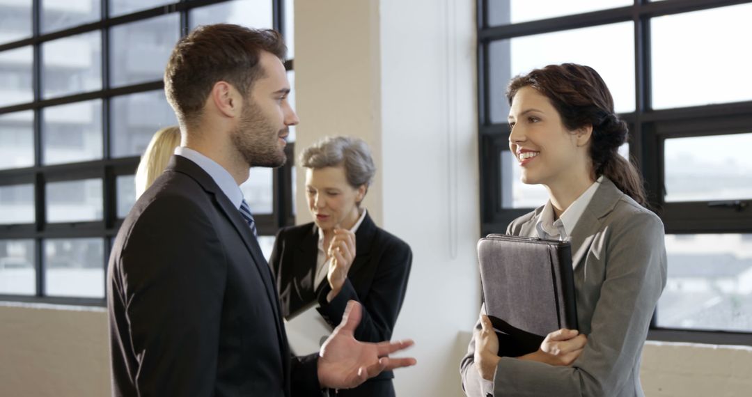 Business Professionals Engaging in Conversation during Office Meeting - Free Images, Stock Photos and Pictures on Pikwizard.com