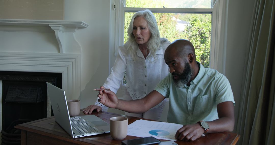 Middle Aged Couple Planning Wedding Merger Using Technology at Home