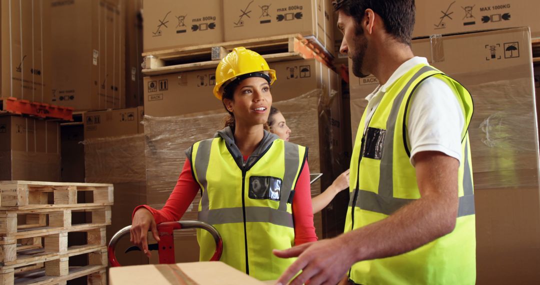 Warehouse Workers Arranging Boxes and Collaborating on Tasks - Free Images, Stock Photos and Pictures on Pikwizard.com