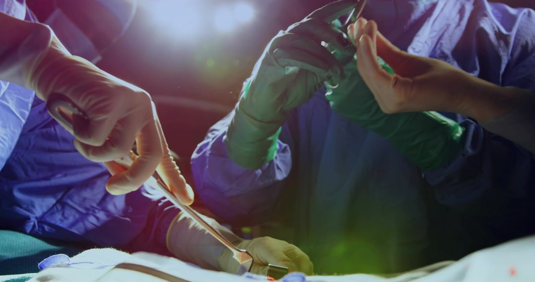 Surgical team performing precise open surgery with gloved hands and scalpel close-up