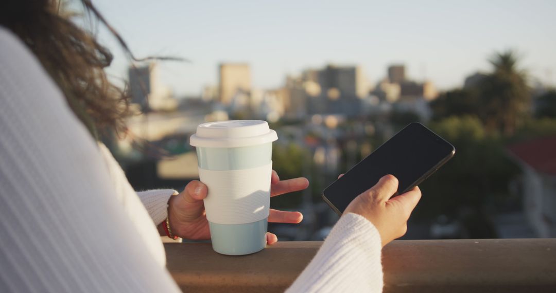 Woman Enjoying City View with Coffee and Smartphone - Free Images, Stock Photos and Pictures on Pikwizard.com